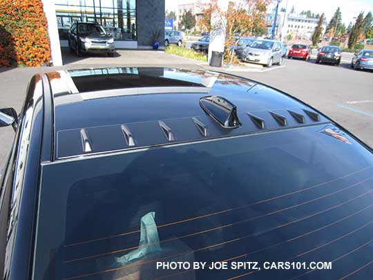 Black STI with optional roof mounted vortex generator, aftermarket tinted windows