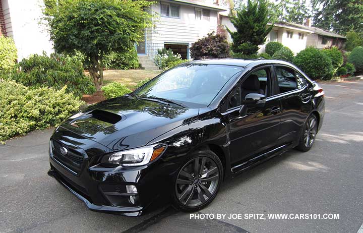 2016 Subaru WRX Limited, 18" 5 split-spoke alloys, black inner headlight surrounds, fog lights. Turn signal outside mirrors means it has optional blind spot detection, possibly Eyesight if a CVT.  crystal black silica shown