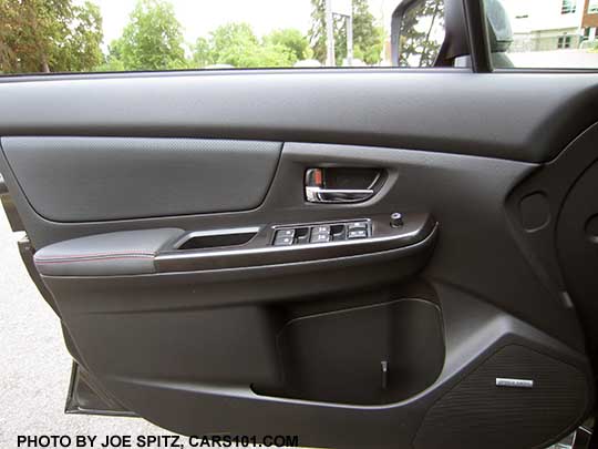 2017 WRX Limited driver's door panel- armrest, bottle holder, chromed inside handle, window, lock, and mirror controls, Harman Kardon logo on the door speaker. The door material is gray leather-matching vinyl