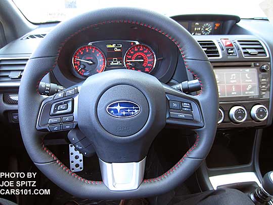 2017 WRX Limited D-shaped, leather wrapped steering wheel with red stitching. Showing 7" audio screen