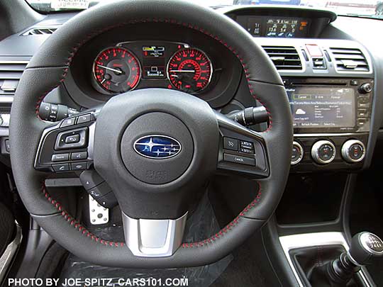 2017 WRX Limited D-shaped, flat bottom,  leather wrapped steering wheel, Red stitching, smooth leather hand grips.  7" audio in the background.