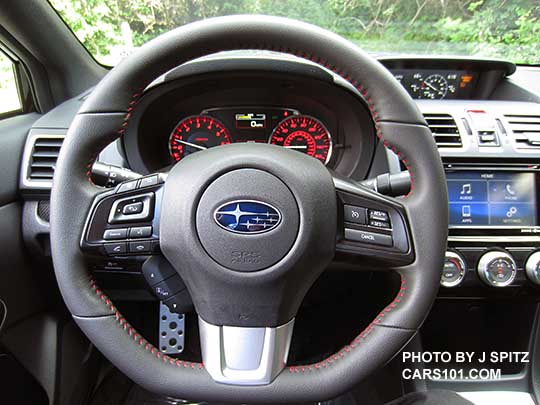 2017 WRX base model D-shaped flat bottom steering wheel, gray leather, smooth leather hand grips, red stitching.  6.2" audio screen in the background