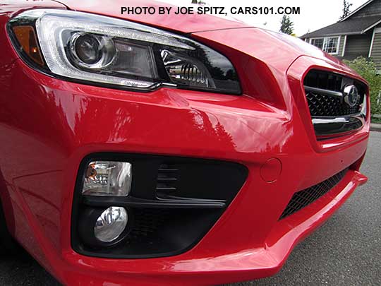 closeup of the 2017 Subaru WRX STI  front view with grill, fog lights, headlight. Pure Red color.