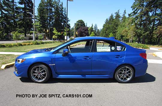 side view World Rally Blue 2017 WRX STI Limited with silver 18" BBS alloys, small rear trunk lip spoiler