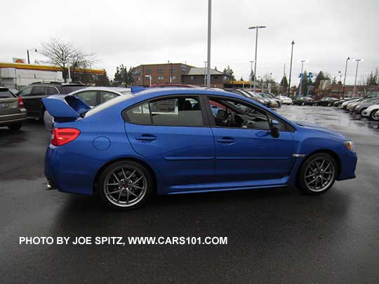 side view 2017 WRX STI Limited with tall wing spoiler, World Rally Blue color shown