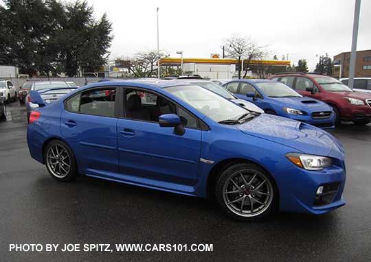 side view 2017 WRX STI Limited with tall wing spoiler, World Rally Blue color shown