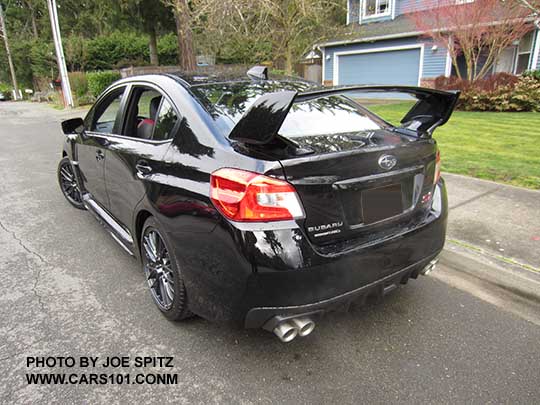 crystal black 2017 Subaru WRX STI with tall wing spoiler, and optional performance exhaust