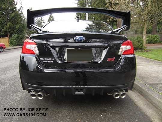 rear view crystal black 2017 Subaru WRX STI with tall wing spoiler, optional performance exhaust