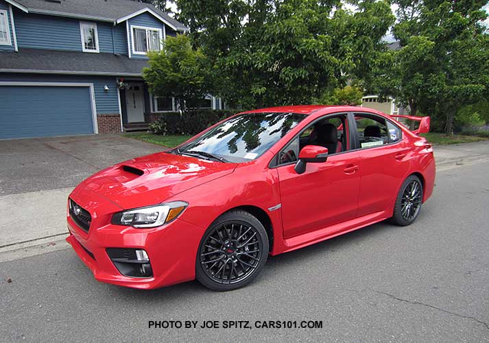 2017 Pure Red STI with tall rear wing spoiler, black 18" alloys.