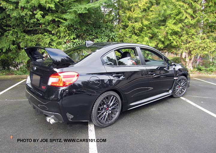 crystal black 2017 Subaru WRX STI with tall wing spoiler and optional performance exhaust