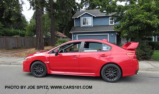 2017 Pure Red STI with tall rear wing spoiler, black 18" alloys.