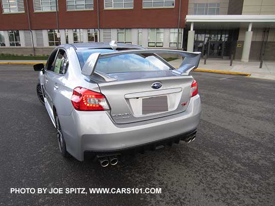 rear view  ice silver 2017 Subaru WRX STI with tall wing spoiler, and optional body side moldings.