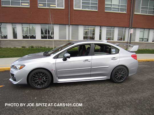 side profile view  ice silver 2017 Subaru WRX STI with tall wing spoiler and optional body side moldings