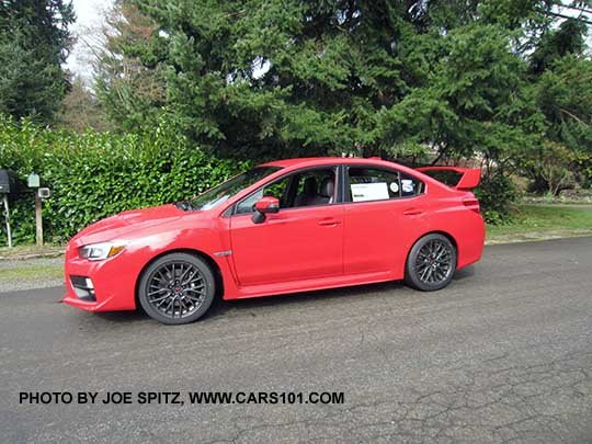 pure red 2017 Subaru WRX STI with tall wing rear spoiler