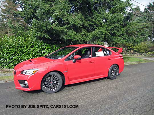 pure red 2017 Subaru WRX STI with tall wing rear spoiler