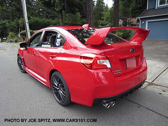 tall rear wing spoiler on a 2017 subaru STI, pure red color shown