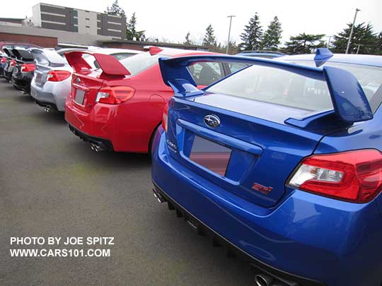 a row of 2017 Subaru WRX STIs with wing spoilers