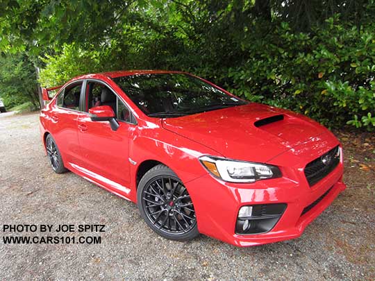 2017 Subaru STI with fog lights, black alloys, wing spoiler.. Pure red color