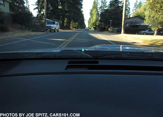 2018 Subaru WRX Eyesight Assist Monitor, showing the center green light on the lower windshield  indicating the Eyesight active cruise control has grabbed a lead vehicle (seen in the distance)