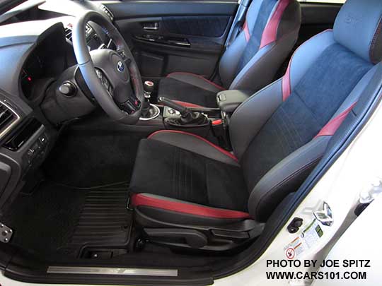 2018 Subaru WRX STI interior- manually adjustable black alcantara driver's seat, red leather bolsters, red stitching, front door STI sill plate. Optional popup center armrest extension.