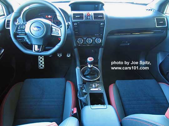 2018 Subaru WRX STI interior dash with gloss black trim, red and black seats with red stitching, center console with DCCD, SI Drive. Shown with optional popup armrest extension