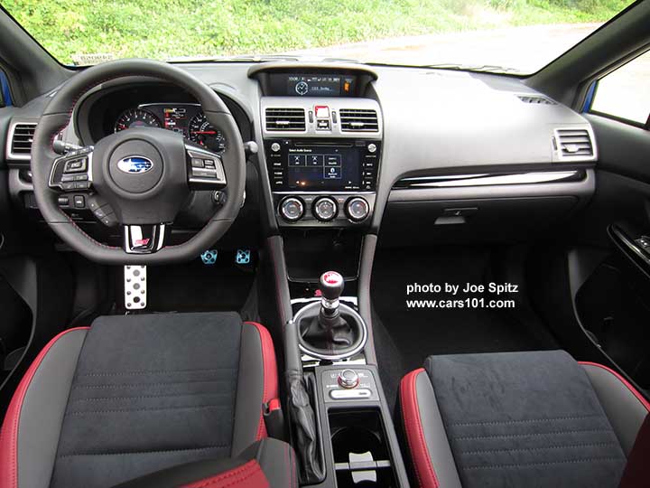 2018 Subaru WRX STI interior, black alcantara seating surfaces with red leather bolsters, red stitching, center console with DCCD, SI Drive, and cupholder with removable divider and sliding cover,  gloss black dash and shift trim