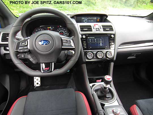 2018 Subaru WRX STI steering wheel with STI logo, black alcantara seating surfaces with red leather bolsters, red stitching, center console with DCCD and front STI logo, gloss black dash and shift trim