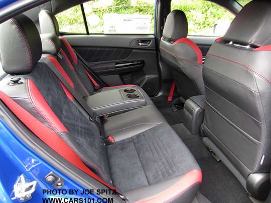 2018 Subaru STI fold down rear seat, black and red seating material, armrest with cupholders.