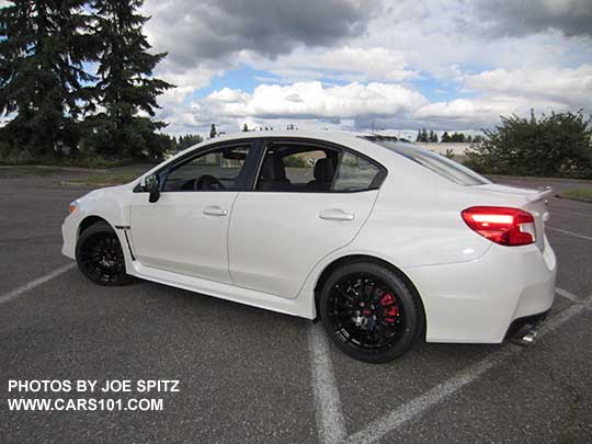 2018 Subaru WRX Premium with optional Vortex generator on the rear roof, and the optional WRX Sport Package with black STI 18" alloy wheels, short shifter, STI exhaust.  Crystal white color