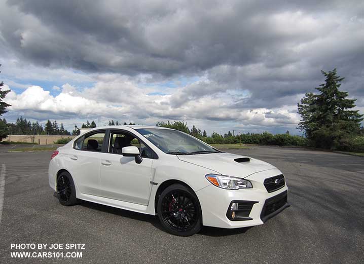 2018 Subaru WRX Premium with the optional WRX Sport Package with short shifter, STI exhaust, and dealer installed black 18" STI alloy wheels. Crystal white color
