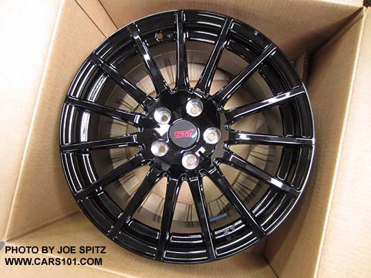2018 Subaru WRX Premium and Limited optional black 18" STI alloy wheel shown in the shipping box, with the STI center cap in place