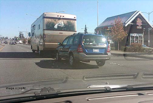 a Subaru Forester being towed behind a motorhome